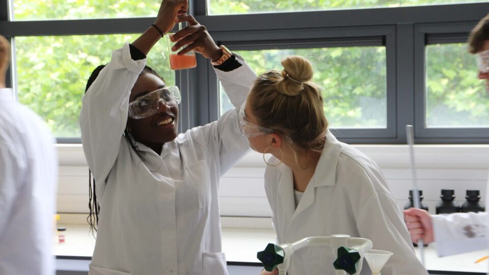 Chemistry students performing experiments in a lab
